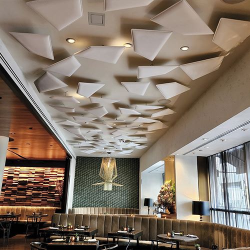 Suspended acoustic panels in a restaurant dining room