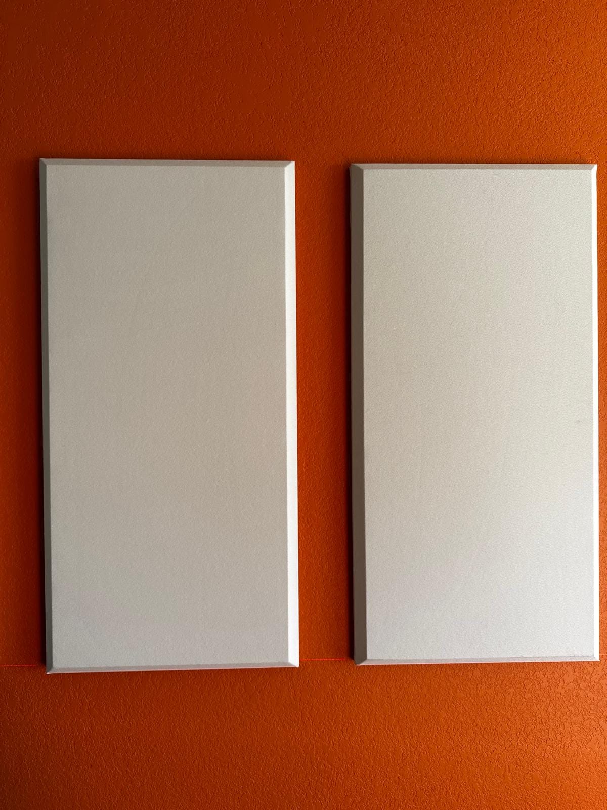 Close-up of two acoustic panels on a media-room accent wall